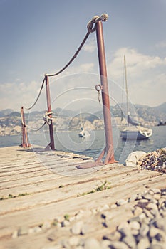 Sailing: Wooden dock pier, sailing boats in the background