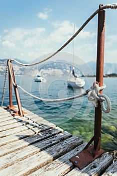 Sailing: Wooden dock pier, sailing boats in the background