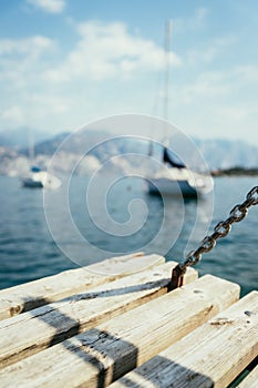 Sailing: Wooden dock pier, sailing boats in the background