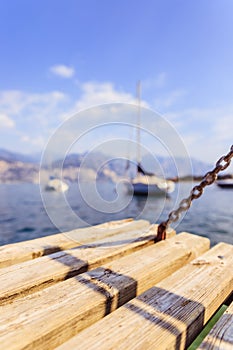 Sailing: Wooden dock pier, sailing boats in the background