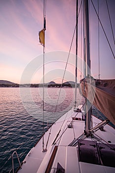Sailing yacht anchoring at the coast in the evening in Mediterranean