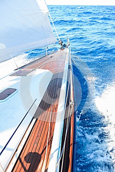 A sailing yacht sailing on the blue sea during sunny wheather photo