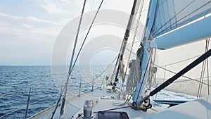 Sailing yacht boat driving thru the ocean on a sunny day