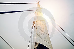 Sailing yacht boat mast from below with sun light from sky