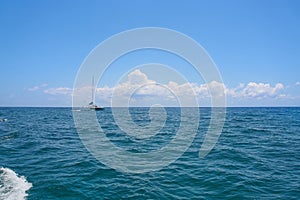 Sailing yacht catamaran sails on the waves in the warm Caribbean Sea. Sailboat. Sailing. Cancun Mexico. Summer sunny day