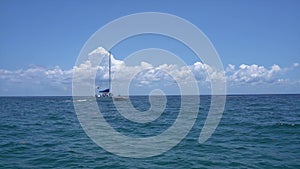 Sailing yacht catamaran sails on the waves in the warm Caribbean Sea. Sailboat. Sailing. Cancun Mexico. Summer sunny day