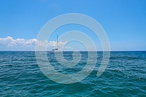 Sailing yacht catamaran sails on the waves in the warm Caribbean Sea. Sailboat. Sailing. Cancun Mexico. Summer sunny day