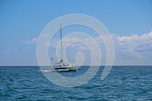 Sailing yacht catamaran sails on the waves in the warm Caribbean Sea. Sailboat. Sailing. Cancun Mexico. Summer sunny day