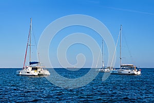 Sailing yacht catamarans, Mediterranean sea, clear blue sky and sea waters. Summer entertainment, fun sailing, swimming