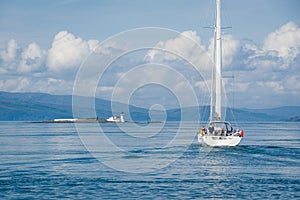 Sailing yacht cruising at Hebrides islands