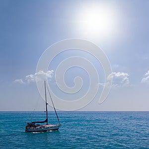 sailing yacht among emerald sea at sunny day