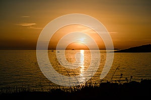Sailing yacht on the horizon, at sunset. A fiery yellow sunset with a sunny path in the Adriatic Sea, off the coast of
