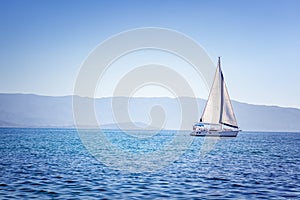 Sailing yacht in Mediterranean sea at sunset. Travel and active