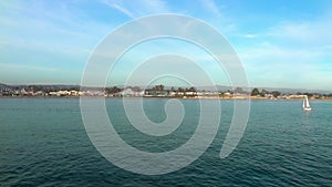 Sailing yacht on the Pacific ocean, as seen from Santa Cruz Beach Boardwalk in Santa Cruz County, California, USA