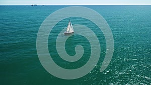 Sailing yacht sails on the sea. Aerial view of mediterranian.