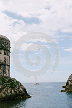 Sailing yacht at sea, sailing in the background Fort Bokar - on the walls of the old city of Dubrovnik, Croatia.