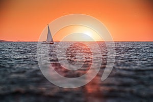 Sailing yacht in the sea at sunset.