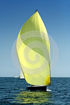 Sailing yacht with spinnaker in the wind