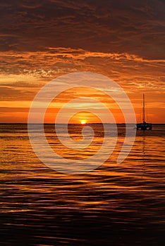 Sailing and yachting. Boat on sea at sunset. Sailboats with sails. Ocean water.