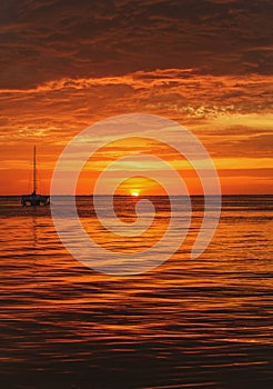 Sailing and yachting. Boat on sea at sunset. Sailboats with sails. Ocean water.