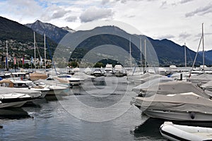 Sailing yachts arranged in rows in a marina covered for winter season and with lowered sails.