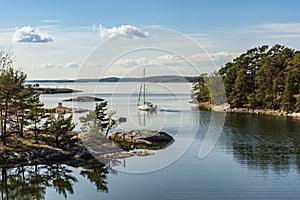 Sailingboat navigating through narrow passage Stockholm archipelago