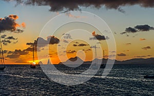 Sailingboat on the ocean under a cloudy sky at sunset