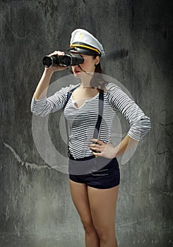 Sailor captain looking for right route in gray background