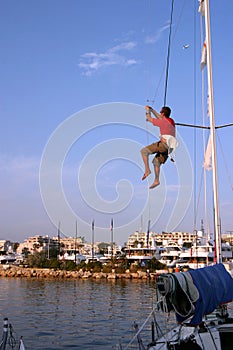 Sailor climbing mast