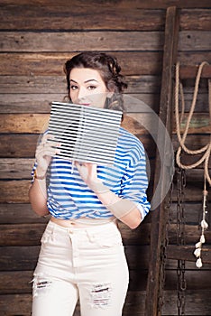 Sailor girl with striped copybook and sailor`s striped vest