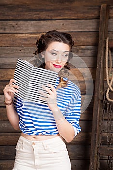 Sailor girl with striped copybook and sailor`s striped vest