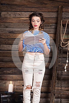 Sailor girl with striped copybook and sailor`s striped vest