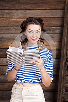 Sailor girl with striped copybook and sailor`s striped vest