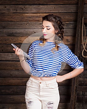 Sailor girl with striped copybook and sailor`s striped vest