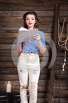 Sailor girl with striped copybook and sailor`s striped vest