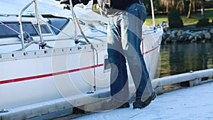 Sailor handling ropes sailboat