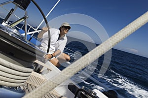 Sailor At Helm of Sailboat photo