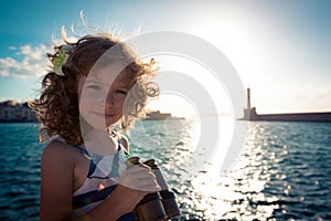 Sailor kid looking through the binoculars