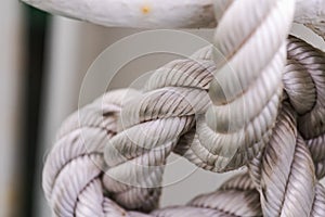 Sailor knot made with thick white rope with white rusty background