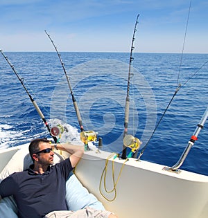 Sailor man fishing resting in boat summer vacation photo
