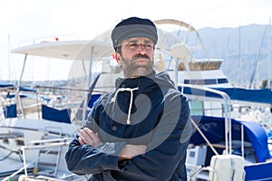 Sailor in marina port with boats background