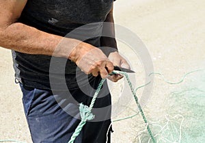 Sailor preparing the fishing nets in the fishing port of Rota, coast of CÃ¡diz, Spain.