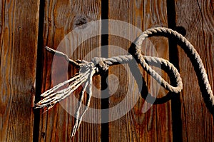 Sailor rope and knot on a wooden pier at the seaside