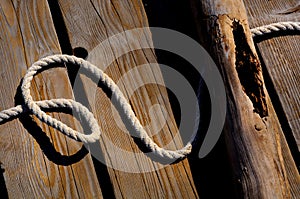 Sailor rope and knot on a wooden pier at the seaside