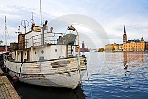 Sailor's old white boat on city background