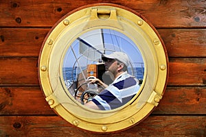 Sailor on sailboat, from boat window photo