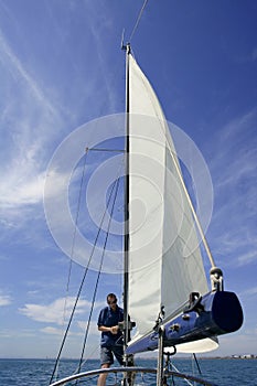 Sailor in sailboat rigging the sails