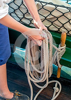 Sailor securing ropes with a sailor knot