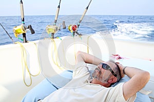 Sailor senior fisherman relax on boat fishing sea