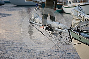 Sailor stands on bowsprit photo